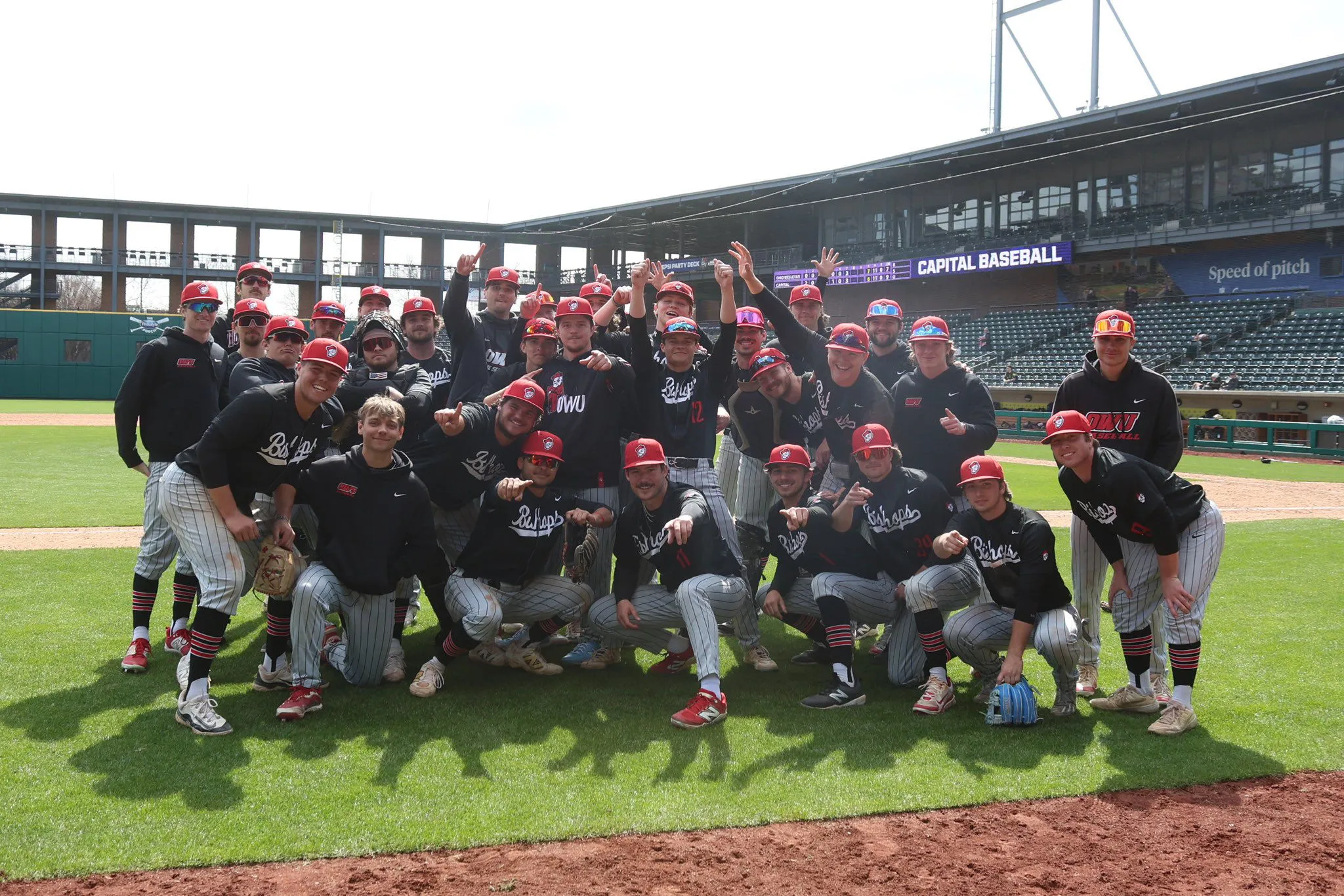 OWU Battling Bishops baseball team celebrating on the field