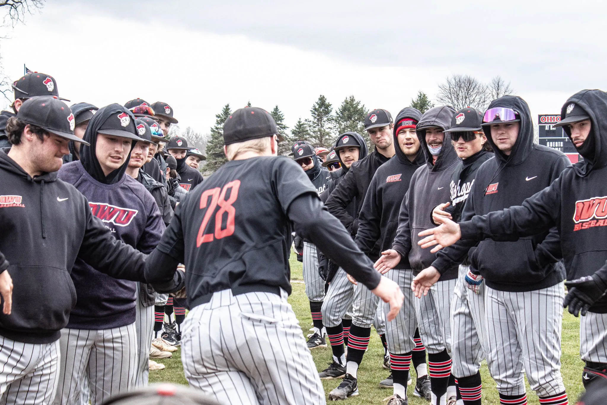 Battling Bishops baseball team huddled together before a game